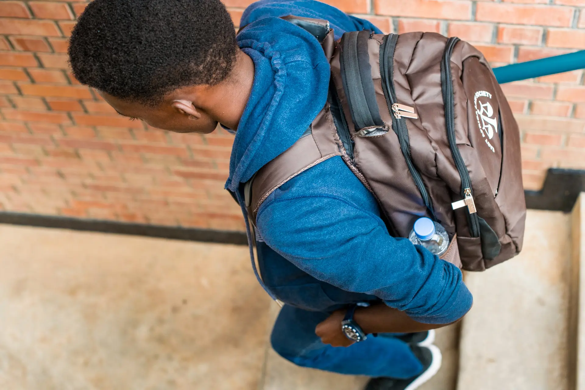 A student with a backpack walking toward school