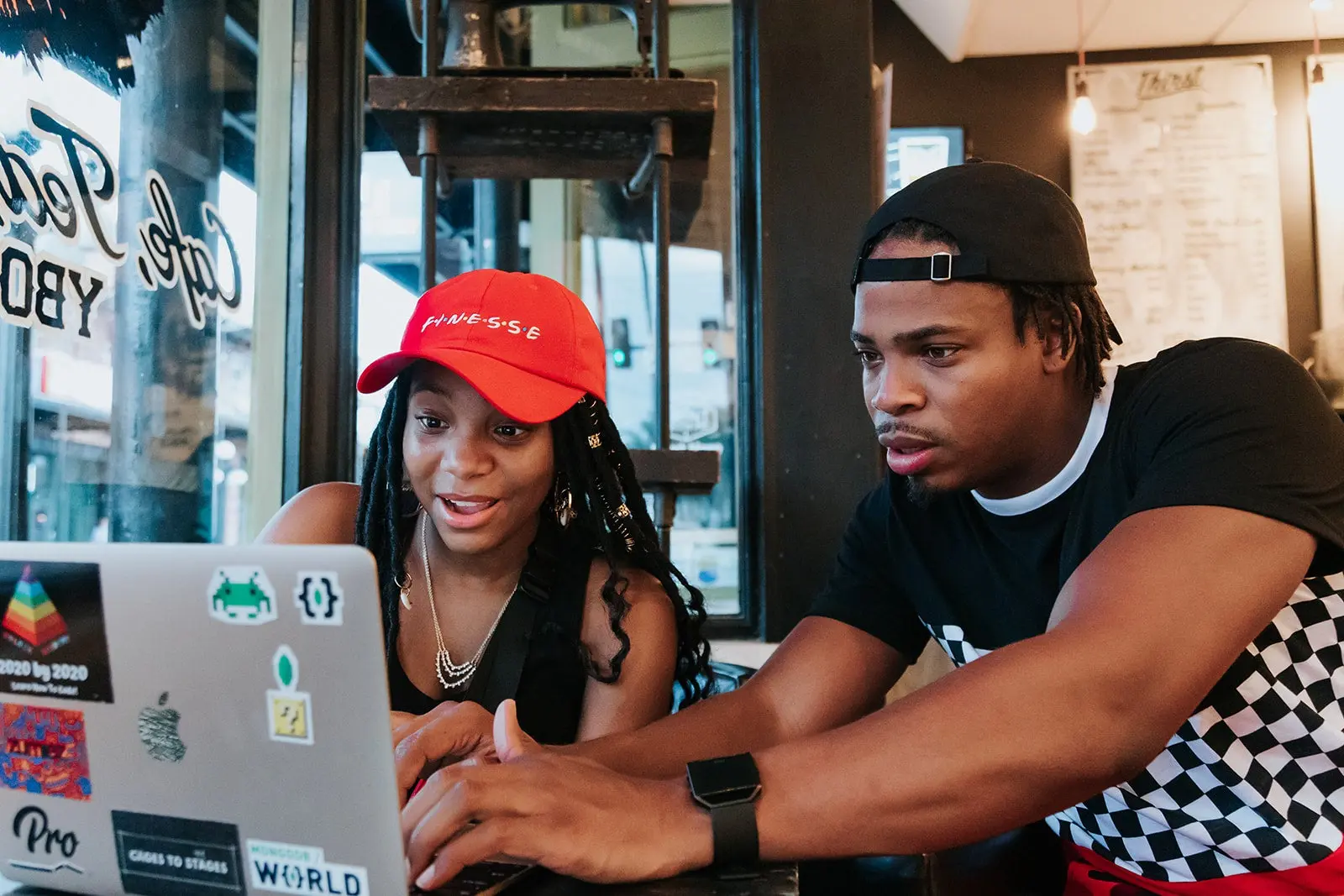 Two young adults working together at a laptop