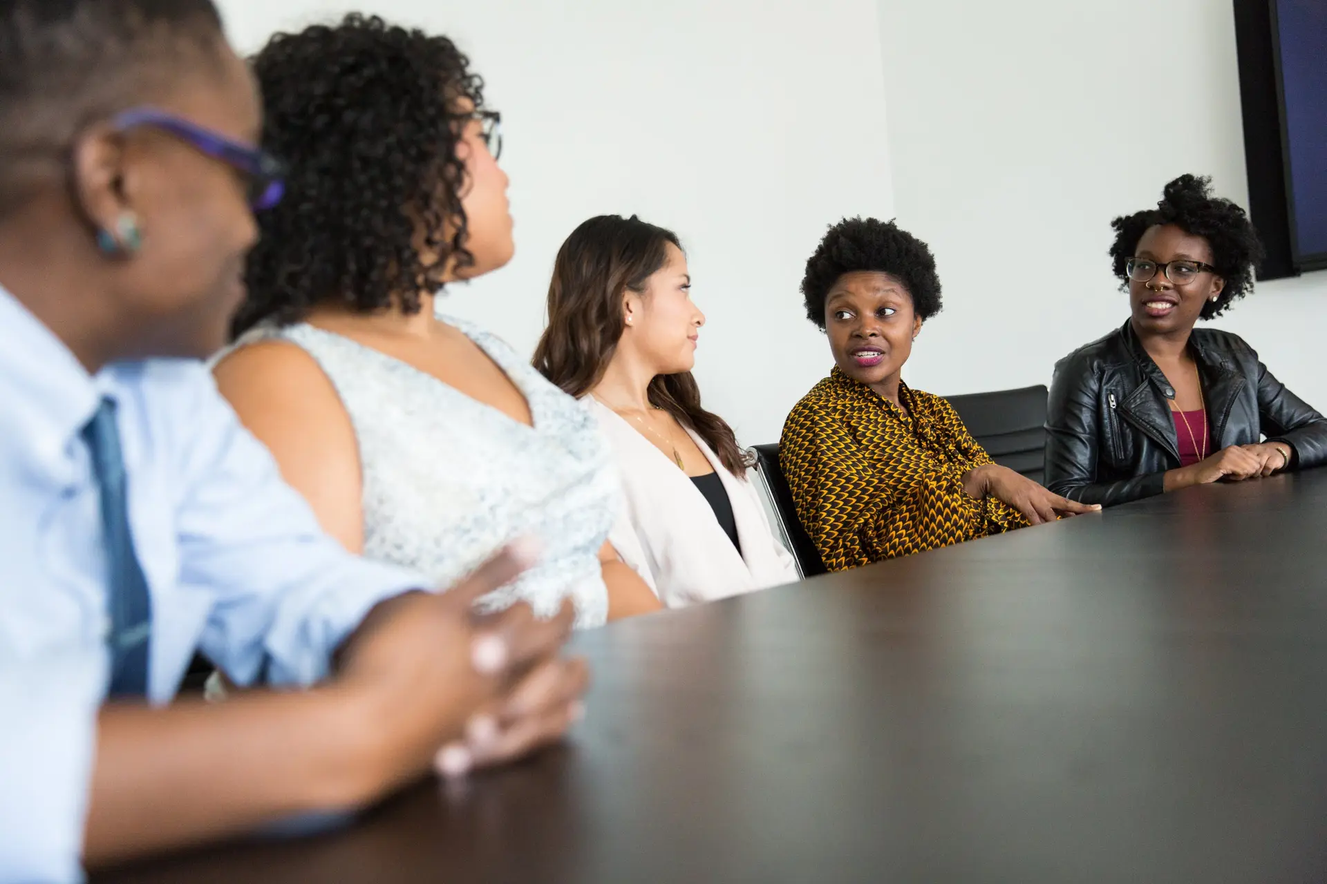 Professionals in conversation around a conference table